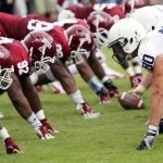 Integrity Meltdown Hits College Football American football players lined up at the line of scrimmage