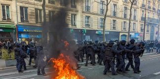 Hundreds Hurt, 1,260 Arrested – Then This Fire burning on the street amid police presence.