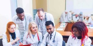 Operating Room Twist: Adenocarcinoma Confirmed Group of medical students collaborating around a laptop