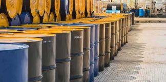 Rows of industrial metal barrels with yellow lids