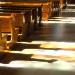 Rap Praising Killers inside Church – Locked Wooden church pews with stained glass light on the aisle