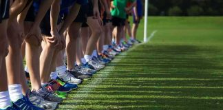 Metal Bottle Turns Sideline Into Crime Scene Runners lined up at a starting line on grass