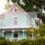 Million-Dollar Fines Hit Wall Street Landlords Victorian house with pastel blue siding and ornate white trim