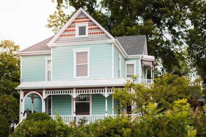 shutterstock_1526393333 Victorian house with pastel blue siding and ornate white trim