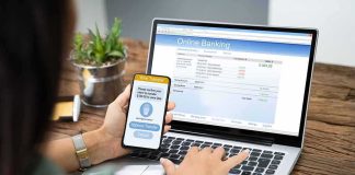 Parental Control Power Shift Hits App Store Person using smartphone to approve bank transfer beside laptop with online banking