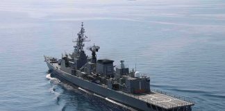 Iran Claims Strike on Tanker as Threats Expand Modern naval warship cruising on calm sea