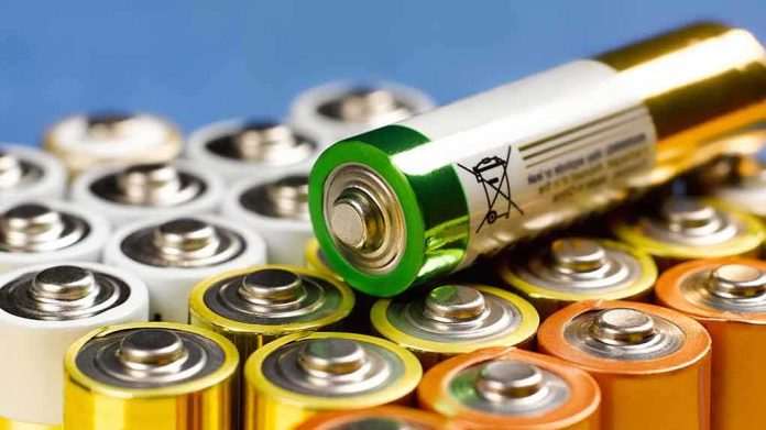 Alkaline batteries stacked with one AA cell on top