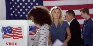 Name Clone Gambit Upends Senate Race Voters at polling booths in front of an American flag