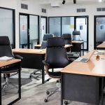 Shock Buyouts Hit Microsoft’s Core Teams Modern open office with empty desks and black chairs
