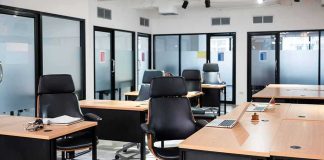 Shock Buyouts Hit Microsoft’s Core Teams Modern open office with empty desks and black chairs