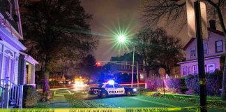 Prosecutors Push Shocking Chainsaw Allegation Police car blocks residential street at night behind caution tape