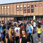 Campus Shock: Dark Room, Bleeding, No Memory Students gathered outside a school building entrance