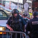 Fifth Avenue Stabbing Sparks Hate-Crime Probe Police officers in tactical gear near a patrol vehicle at night