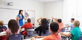 Schools Hid Transitions – Policy OVERTURNED Teacher leading classroom discussion with students raising hands