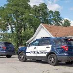Texas Mother Arrested After Both Sons Die Two police SUVs parked near a suburban house