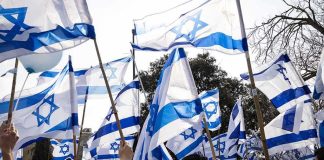 Follow The Money: AIPAC Rewires 2026 Crowd waving Israeli flags outdoors
