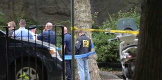 Daytona Rally Threat Triggers FBI Blitz law enforcement officers gather at taped-off outdoor scene