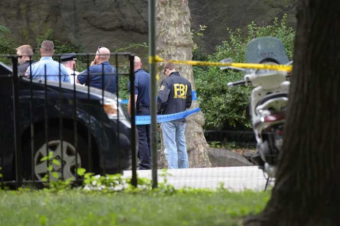 shutterstock_451587268-1 law enforcement officers gather at taped-off outdoor scene