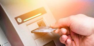 Bank Of America Oops – Barber Makes A Call Hand inserting bank card into ATM slot