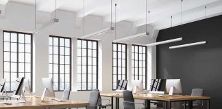 AI Bills Spike – Microsoft Dangles Exit Cash modern open-plan office with large windows and desks